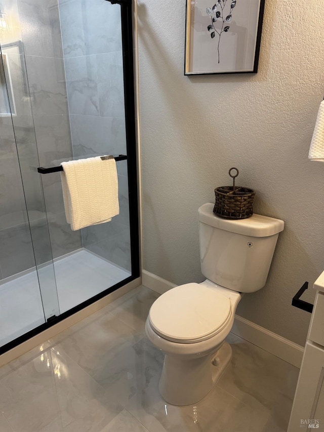 full bath with baseboards, marble finish floor, a shower stall, and toilet