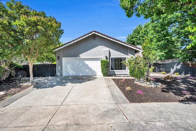 4187 Tokay Dr, Napa, CA 94558 - ranch-style house featuring fence, stucco siding, an attached garage, a tiled roof, and driveway