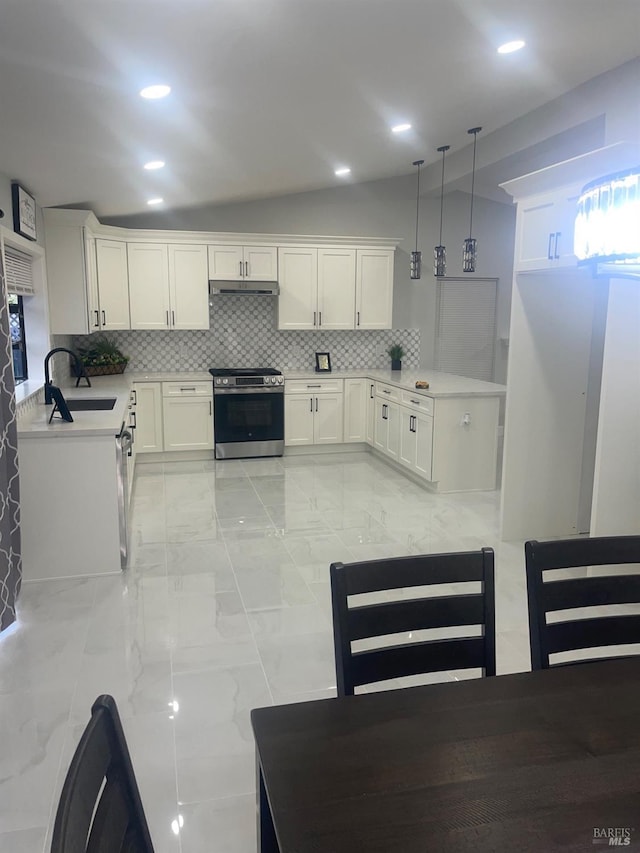 kitchen featuring white cabinets, stainless steel range with electric cooktop, light countertops, a sink, and decorative backsplash