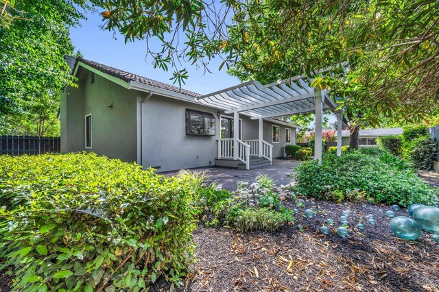 4187 Tokay Dr, Napa, CA 94558 - back of house featuring stucco siding, a pergola, and fence