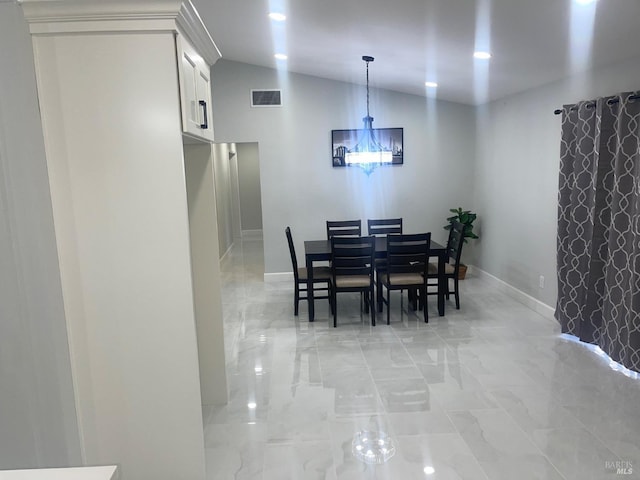 dining space featuring visible vents, baseboards, marble finish floor, and lofted ceiling