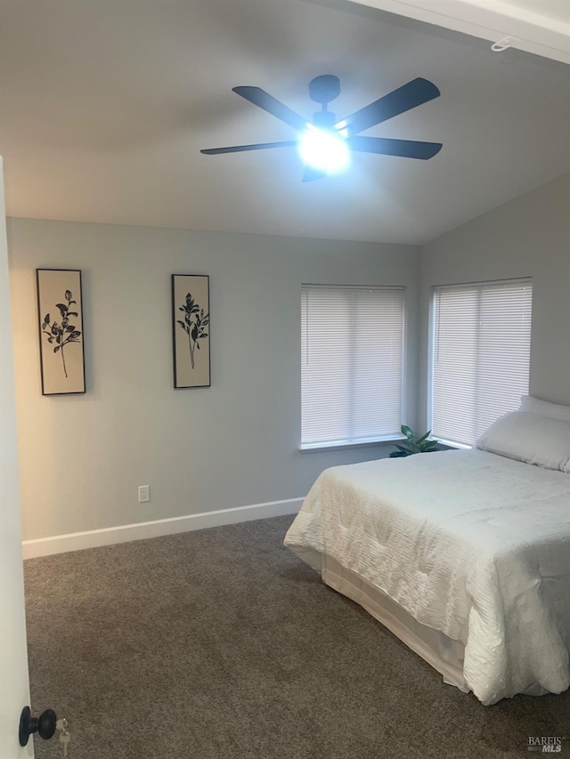 carpeted bedroom featuring vaulted ceiling, baseboards, and ceiling fan