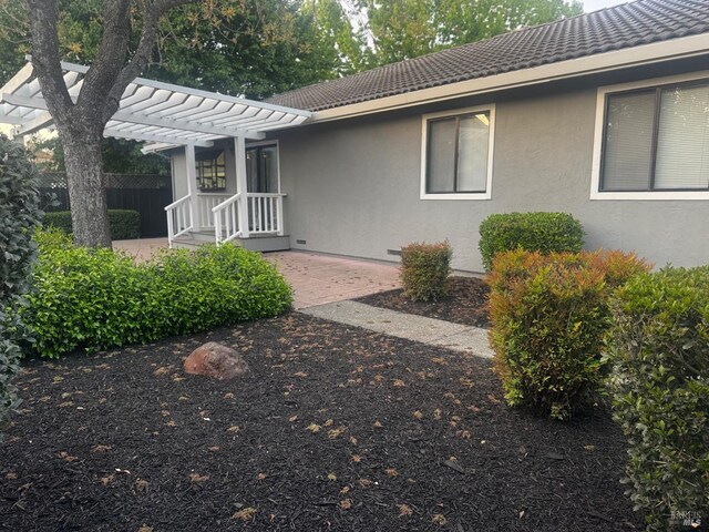4187 Tokay Dr, Napa, CA 94558 - view of front facade with a pergola, stucco siding, a patio area, and fence