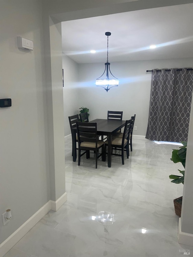 dining space with marble finish floor and baseboards