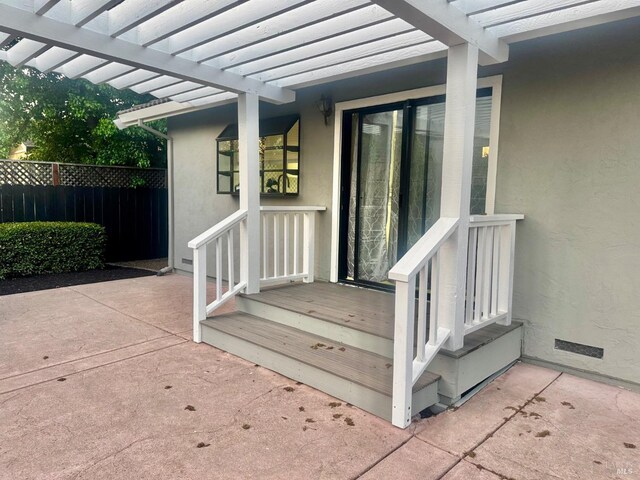 4187 Tokay Dr, Napa, CA 94558 - view of exterior entry with stucco siding, fence, a pergola, and a patio area