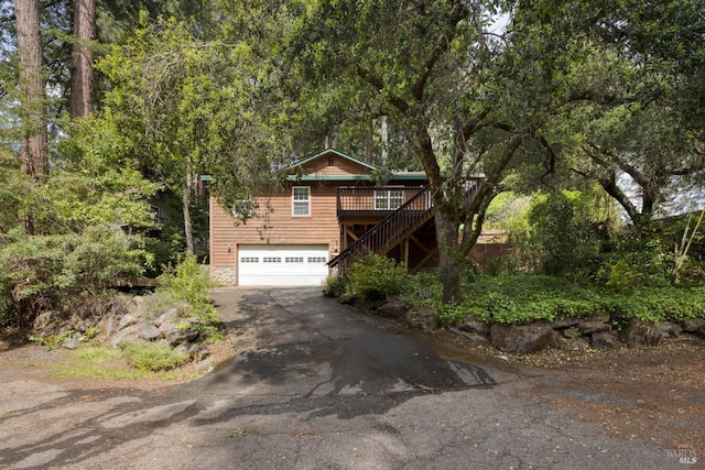 16589 Glenda Dr, Guerneville, CA 95446 - view of front facade with asphalt driveway, stairs, a garage, and a wooden deck