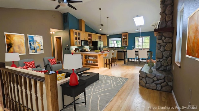 16589 Glenda Dr, Guerneville, CA 95446 - living area with light wood-style flooring, ceiling fan, baseboards, and high vaulted ceiling