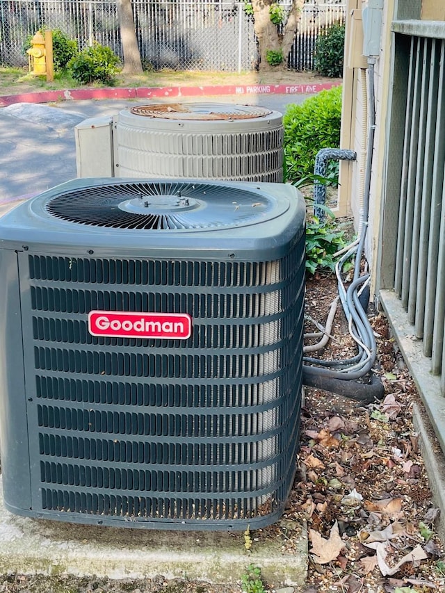 exterior details featuring fence and cooling unit
