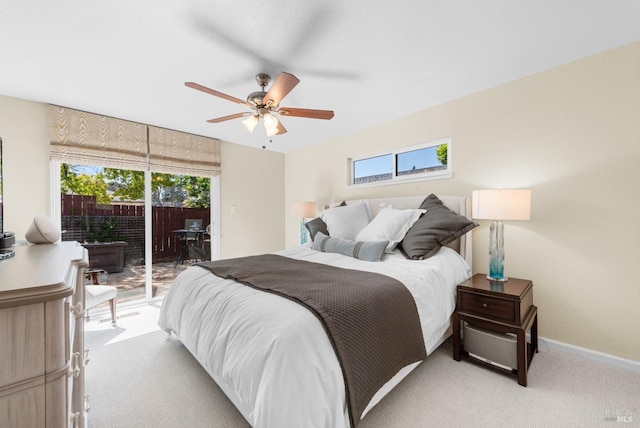 bedroom featuring multiple windows, light colored carpet, and access to outside