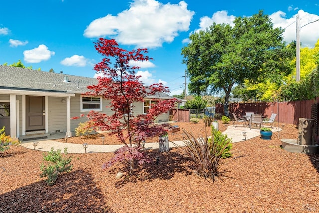 view of yard featuring fence and a patio