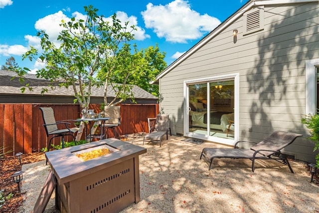view of patio with fence and an outdoor fire pit