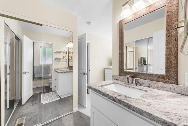 full bathroom with visible vents, vanity, and toilet