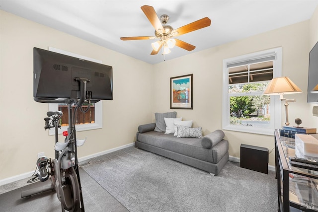 exercise room with carpet flooring, baseboards, and ceiling fan
