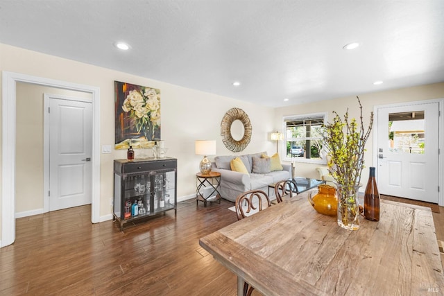 dining space featuring baseboards, wood finished floors, and recessed lighting