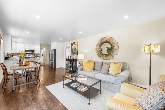 living area with baseboards, dark wood-style floors, and recessed lighting
