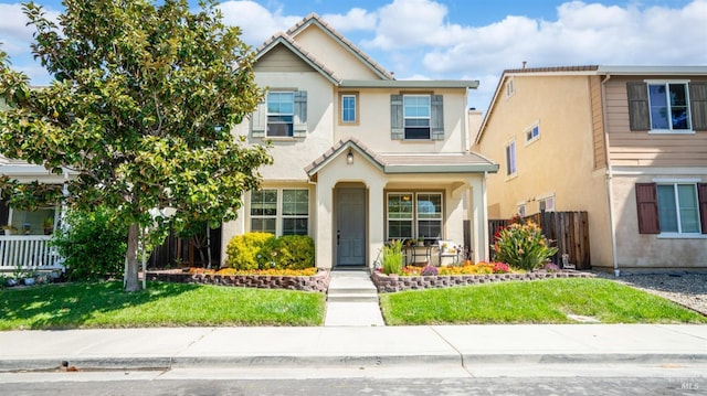 1220 Bello Dr, Dixon, CA 95620 - traditional-style house with fence, a porch, a front lawn, and stucco siding