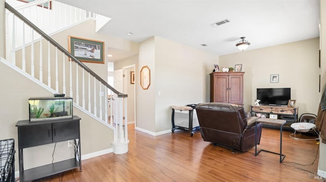 1220 Bello Dr, Dixon, CA 95620 - living area featuring stairway, baseboards, wood finished floors, and visible vents