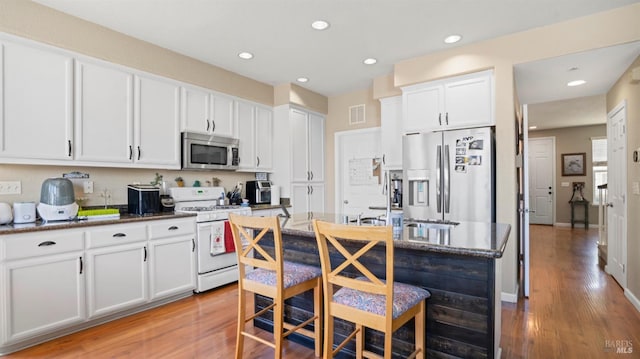 1220 Bello Dr, Dixon, CA 95620 - kitchen with white cabinets, light wood-style flooring, visible vents, recessed lighting, and appliances with stainless steel finishes