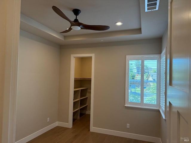 mudroom featuring arched walkways, wood finished floors, and baseboards