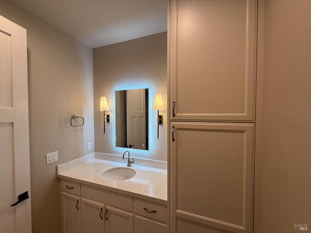 kitchen with beverage cooler, arched walkways, stainless steel built in fridge, wall chimney range hood, and white cabinetry