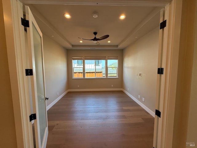 spare room with wood finished floors, ceiling fan, recessed lighting, and baseboards