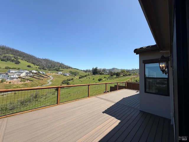 wooden terrace featuring a mountain view and a rural view