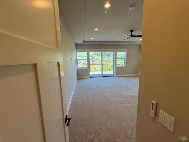 unfurnished room with recessed lighting, a raised ceiling, a ceiling fan, and light colored carpet