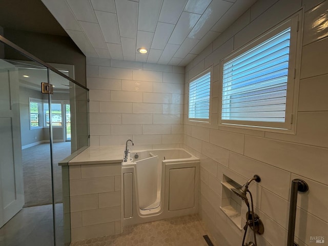 bathroom with a garden tub, a shower stall, and recessed lighting