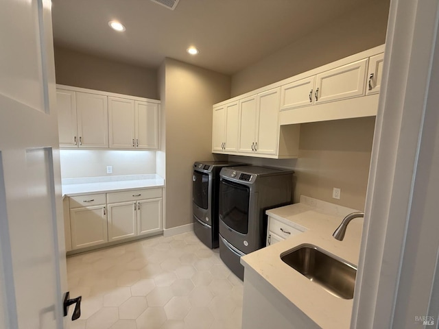 laundry room featuring recessed lighting, independent washer and dryer, light tile patterned floors, cabinet space, and a sink