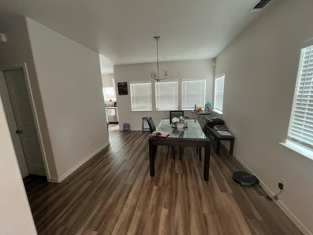 dining space with baseboards, visible vents, dark wood-style flooring, and a notable chandelier