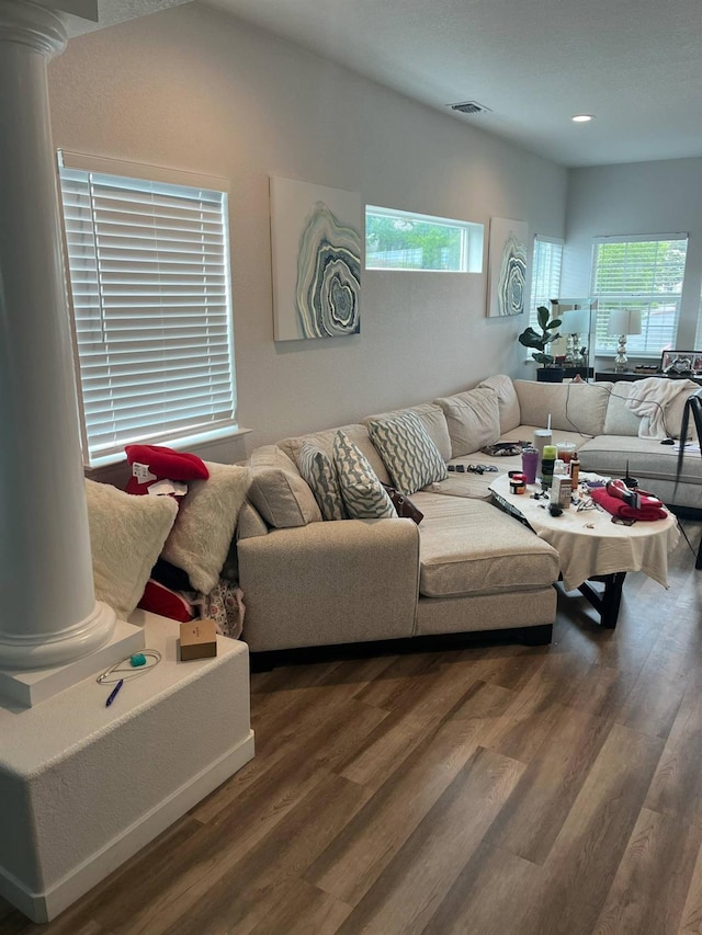 living area with visible vents, recessed lighting, decorative columns, and wood finished floors
