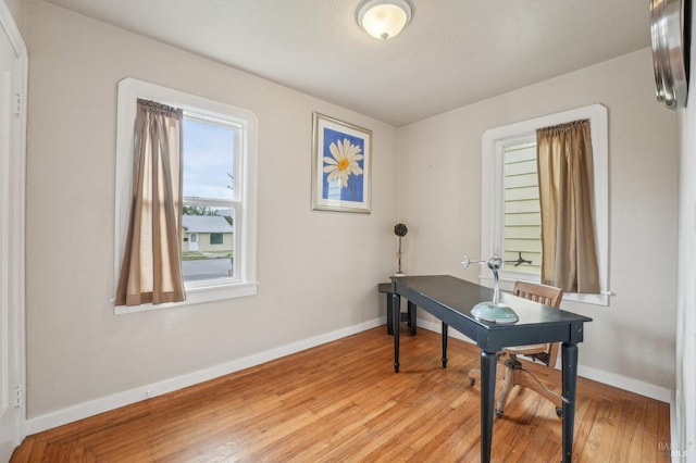 office area with light wood finished floors and baseboards