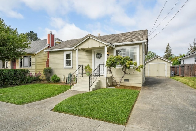 bungalow featuring a garage, driveway, fence, an outbuilding, and a front yard