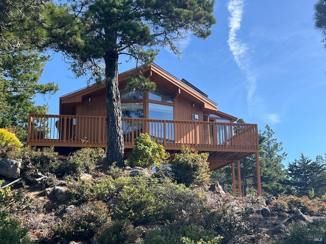 42227 Roseman Creek Rd, Gualala, CA 95445 - rear view of house with a patio area, solar panels, roof with shingles, and a deck