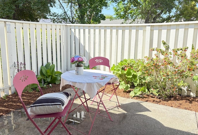 balcony featuring outdoor dining area and a patio