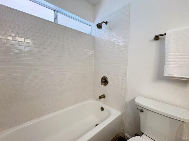 bathroom featuring toilet and  shower combination