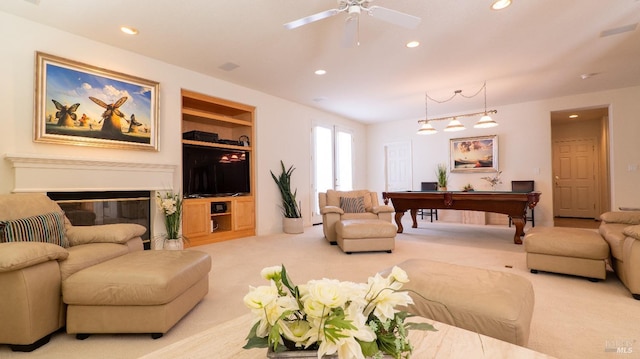 carpeted living area featuring recessed lighting, a glass covered fireplace, pool table, and a ceiling fan