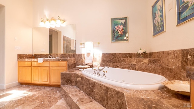 bathroom featuring vanity and a jetted tub