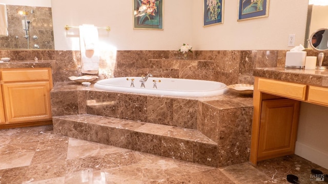 full bath featuring a garden tub, vanity, marble finish floor, and a walk in shower