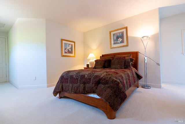 carpeted bedroom featuring baseboards