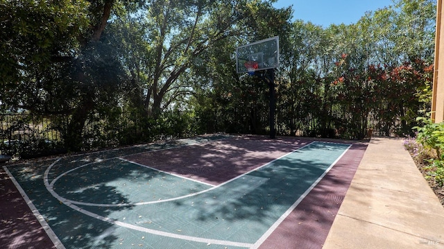 view of sport court with fence and basketball hoop