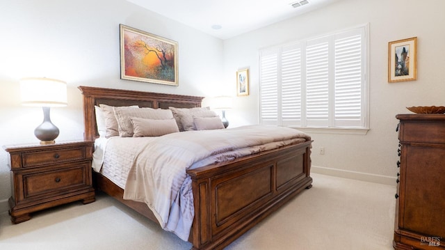bedroom featuring visible vents, baseboards, and light colored carpet