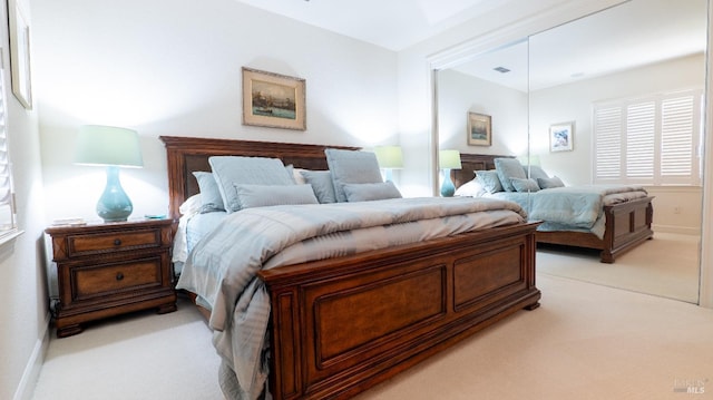 bedroom with light carpet and visible vents