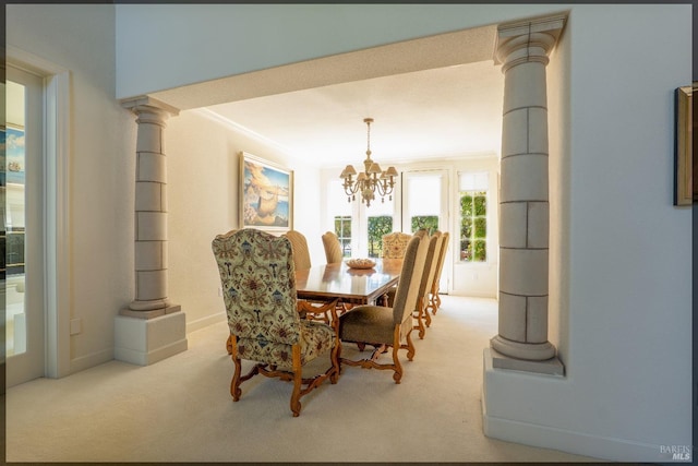 dining area with decorative columns, baseboards, an inviting chandelier, crown molding, and carpet floors