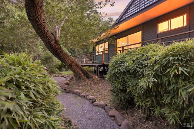 property exterior at dusk with a deck