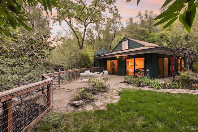 back of property with an outdoor hangout area and a patio area