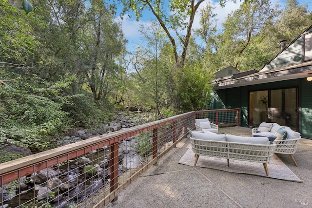 balcony featuring an outdoor living space and a patio