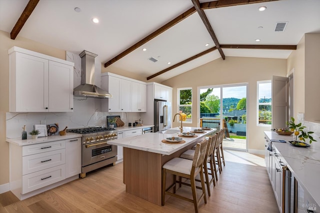 431 Seymour St, Napa, CA 94559 - kitchen with high quality appliances, wall chimney range hood, decorative backsplash, light stone countertops, and light wood-type flooring