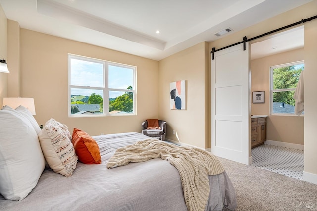 bedroom with a barn door, baseboards, carpet flooring, visible vents, and recessed lighting