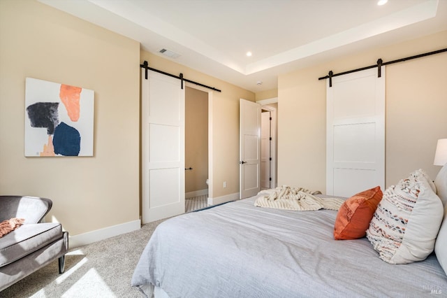 carpeted bedroom with visible vents, recessed lighting, and a barn door